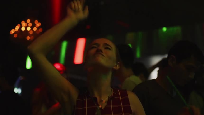 People dance and jump in the club
