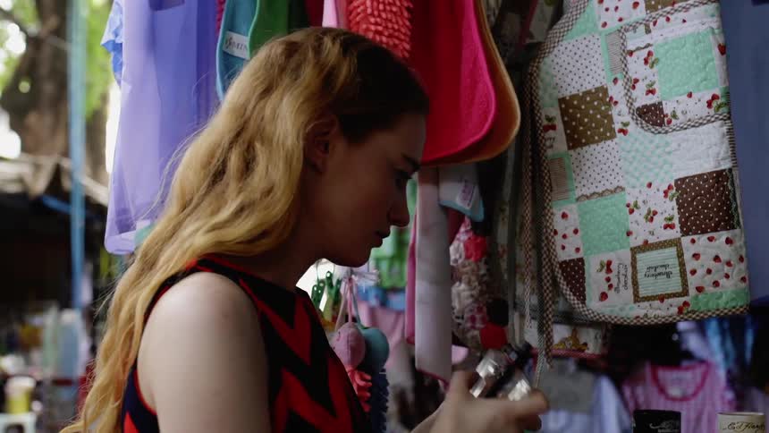 A woman is checking out items in an outdoor shop
