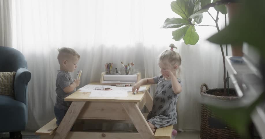 A boy and girl color at home