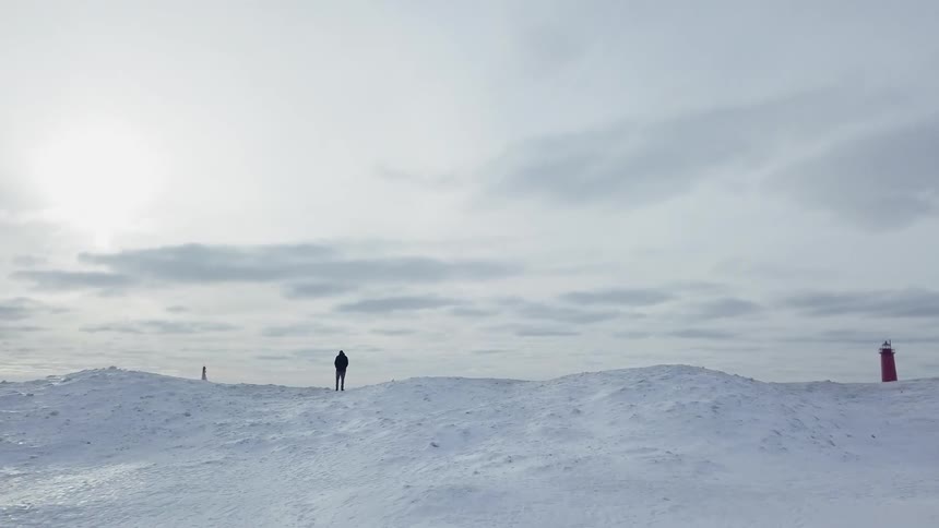 A man stands on a hill in the snow