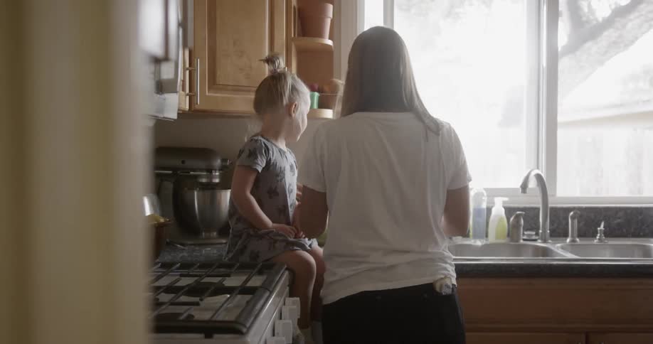 Mother and daughter cooking in the kitchen together