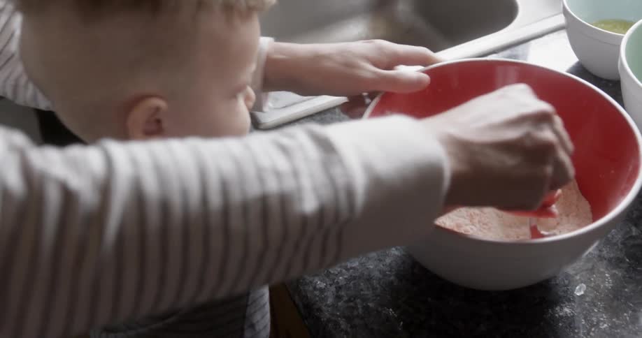 A parent cooks with their child at home