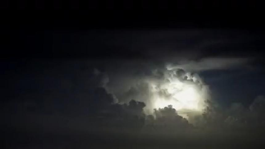 Lightening is lighting up the clouds at night during storm