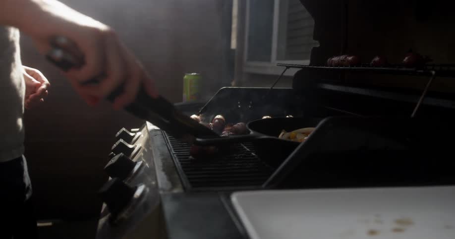A person is cooking on the grill