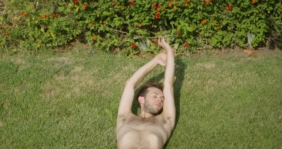 A man is resting in the grass