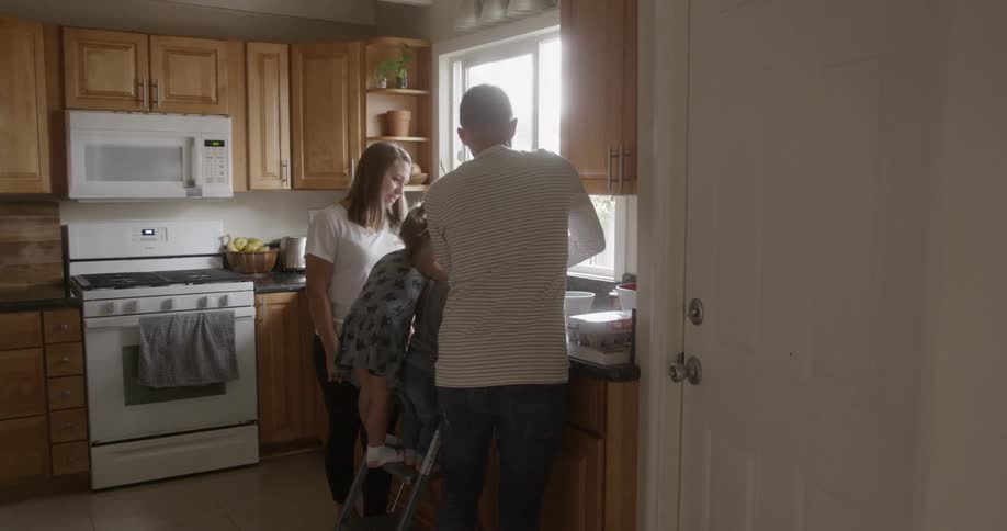A family cooking together in the kitchen
