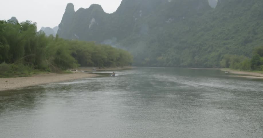 A boat floats on a mountain river