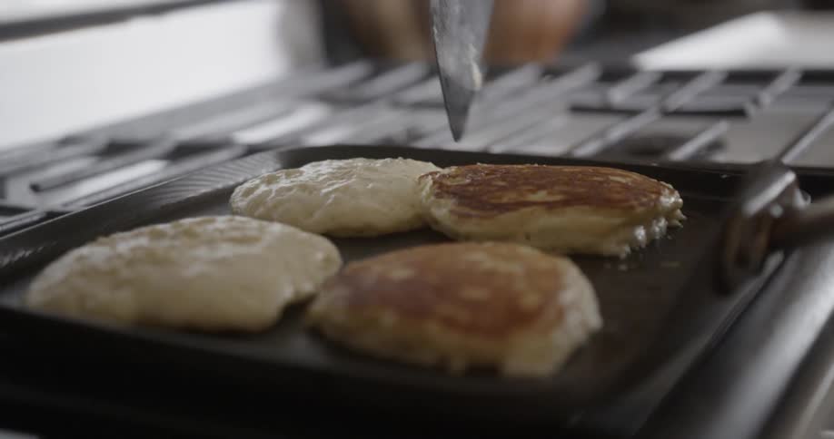 Pancakes are cooked on a stovetop