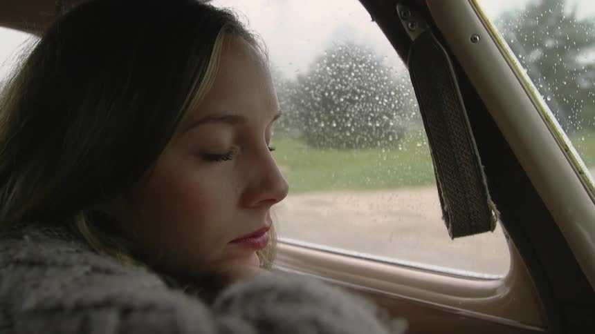 Woman closes her eyes in car