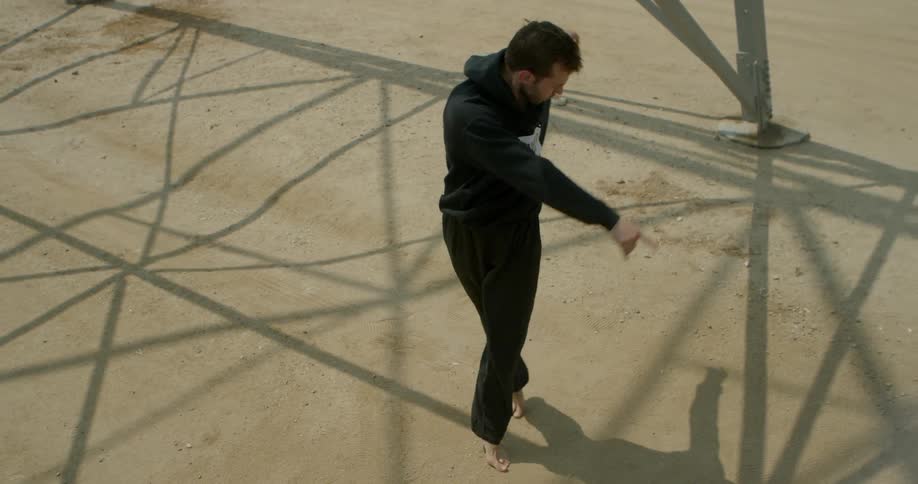 Man is dancing ballet outside on sunny day