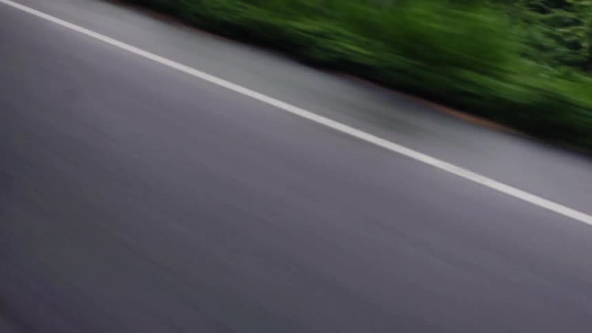 A car drives on a paved road