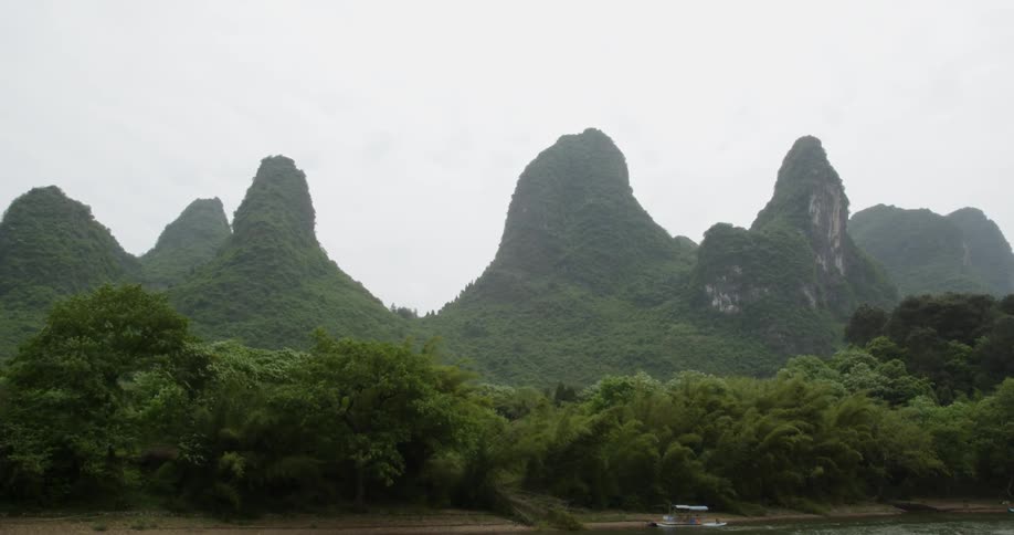 Lush green forest and mountains on cloudy day