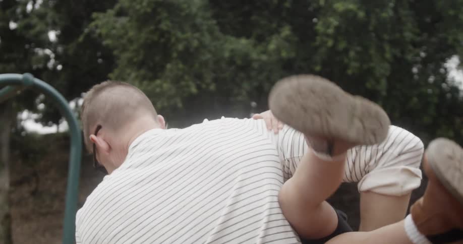 A man holds his daughter outside