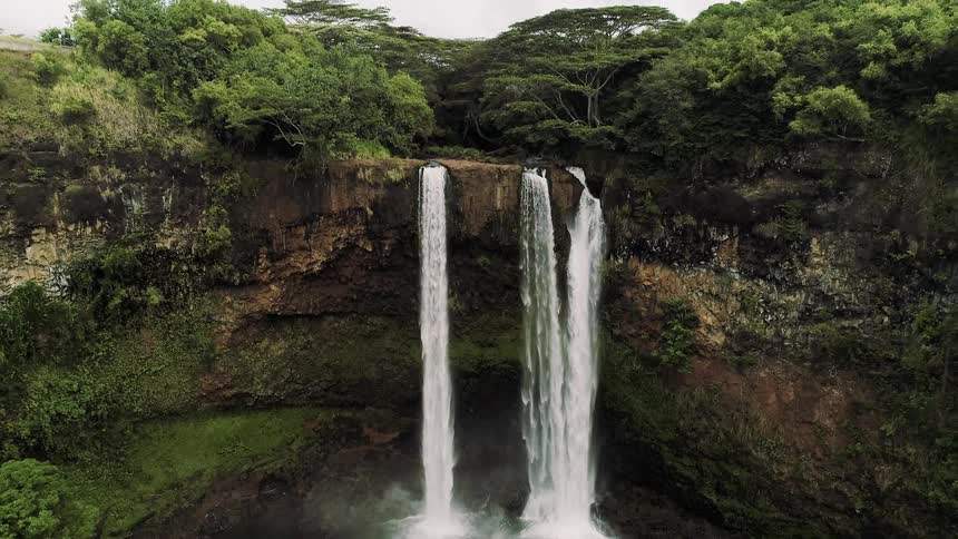 Water falls from the cliff into the ravine