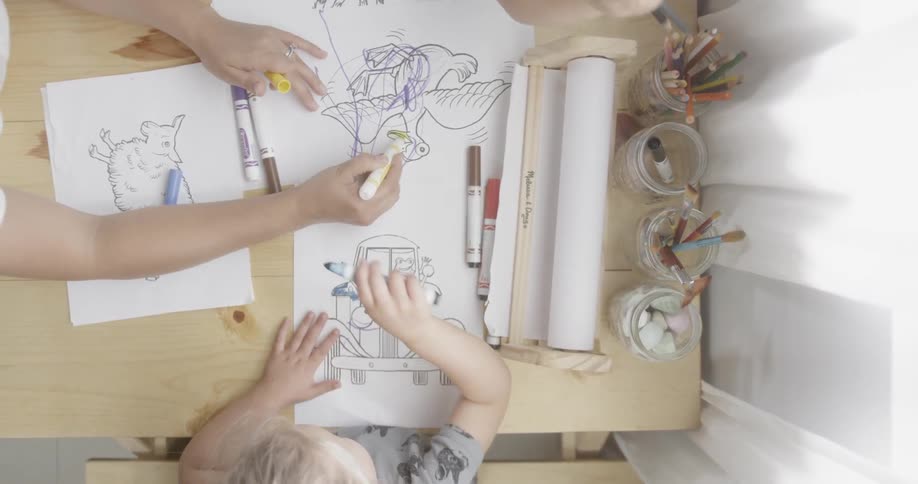 Children are coloring together at the table