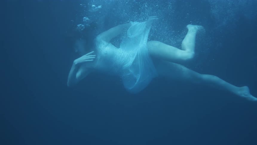 A woman dives into the water and sinks