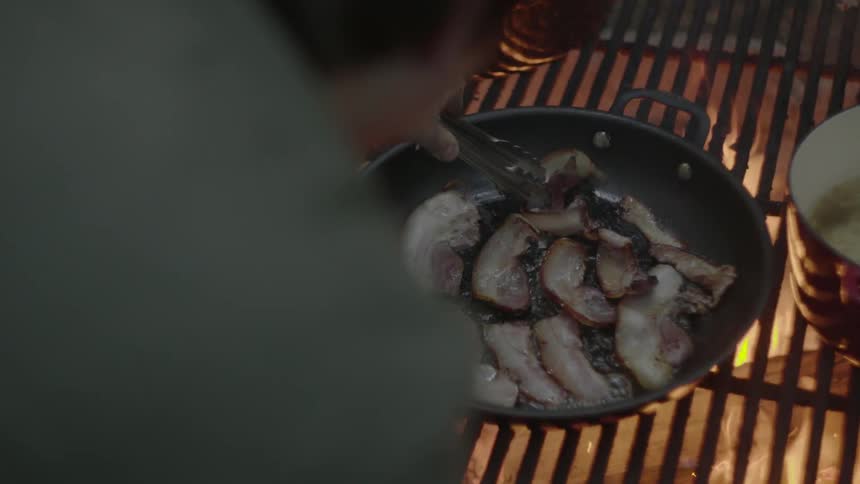A person cooking on a grill