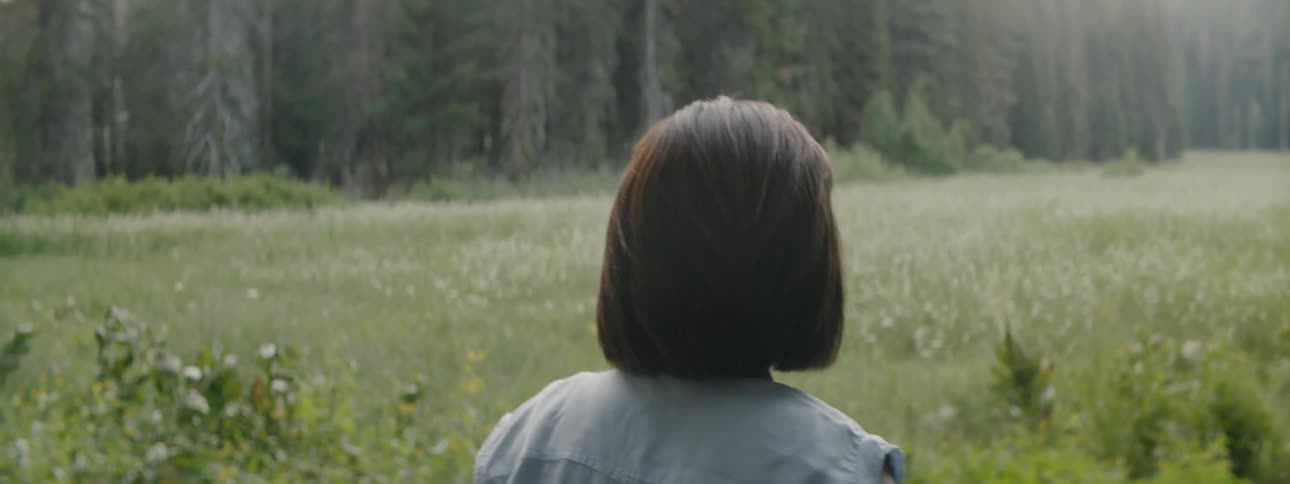 Woman takes a photo of a field with her cellphone