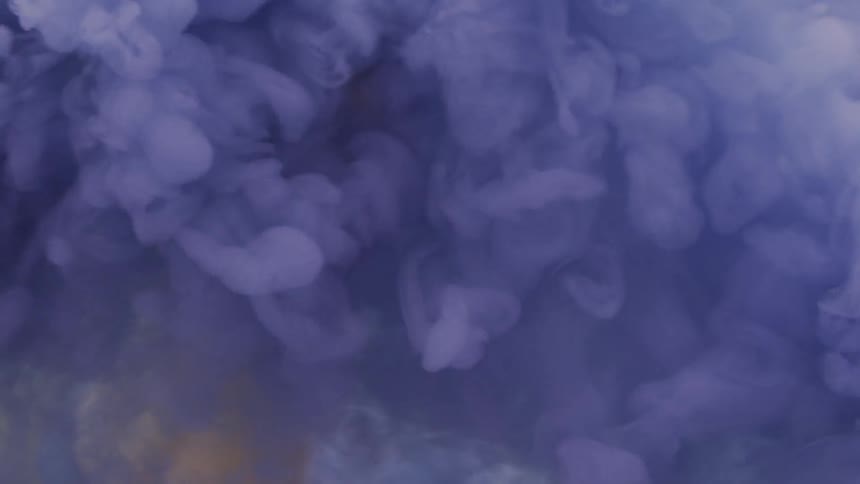 Man tries to grab the colored smoke that floats by