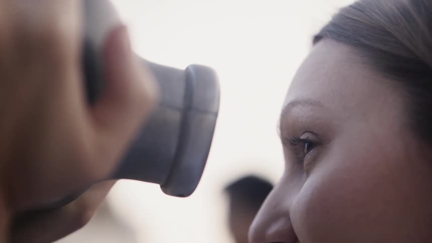 The woman looks through the binoculars