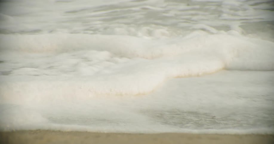 Ocean water flowing up onto sand beach