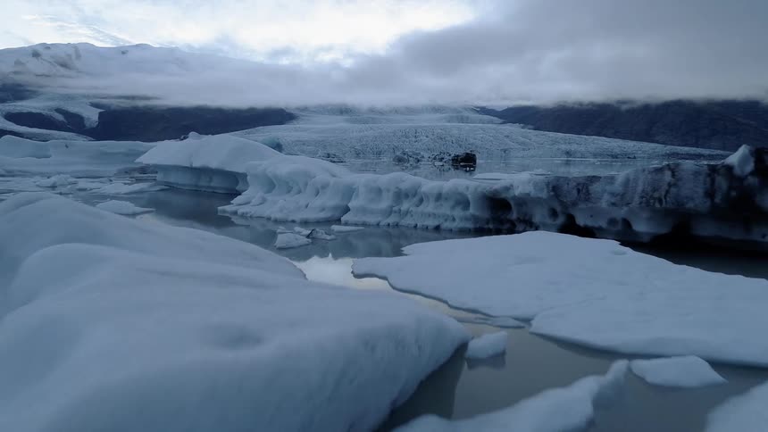 Ice and snow float on a lake in the wilderness