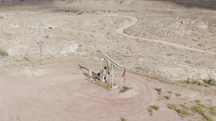 An oil drill rig operates in a rural area