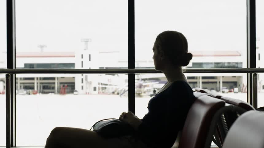 A woman waits in an airport