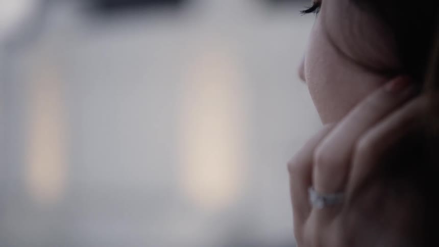 Closeup of Thoughtful Woman with Diamond Wedding Rings