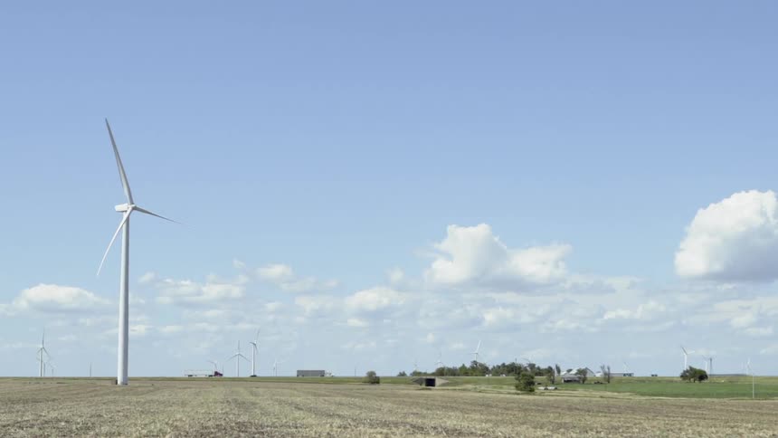 The cars drive past the windmill