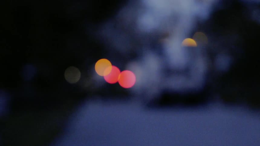 Lights from a city vehicle shine and blink at night