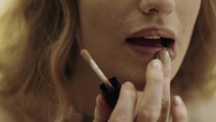 A woman puts on makeup