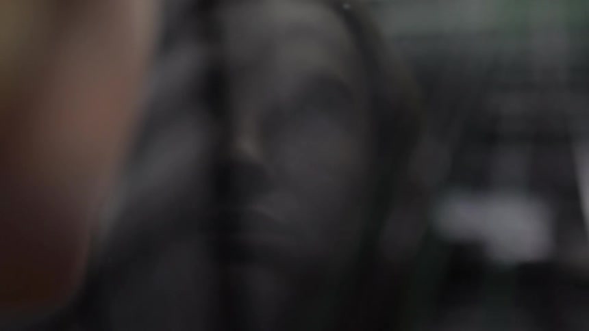A woman looks out of a train window