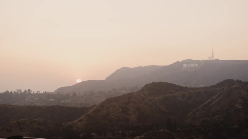 The sun shines beyond the hills