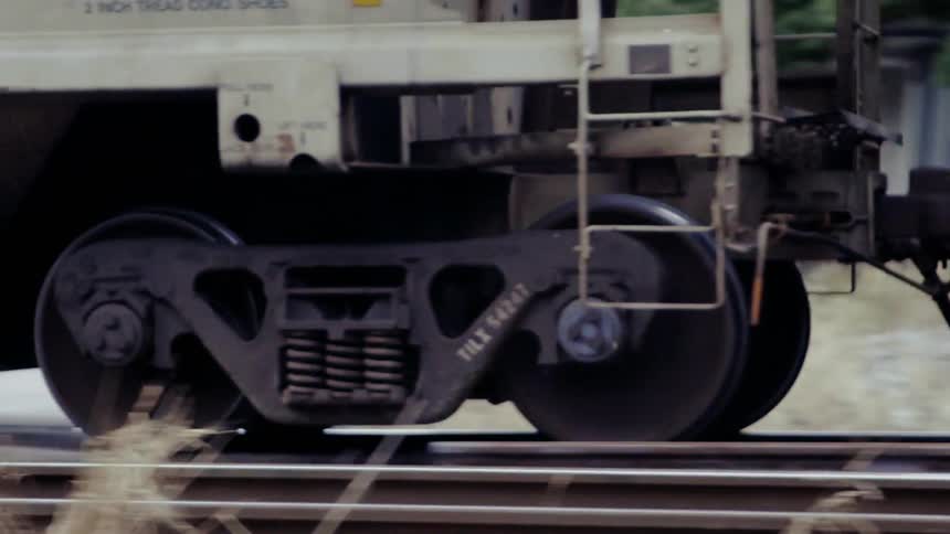 Train rolls down the tracks on a sunny day