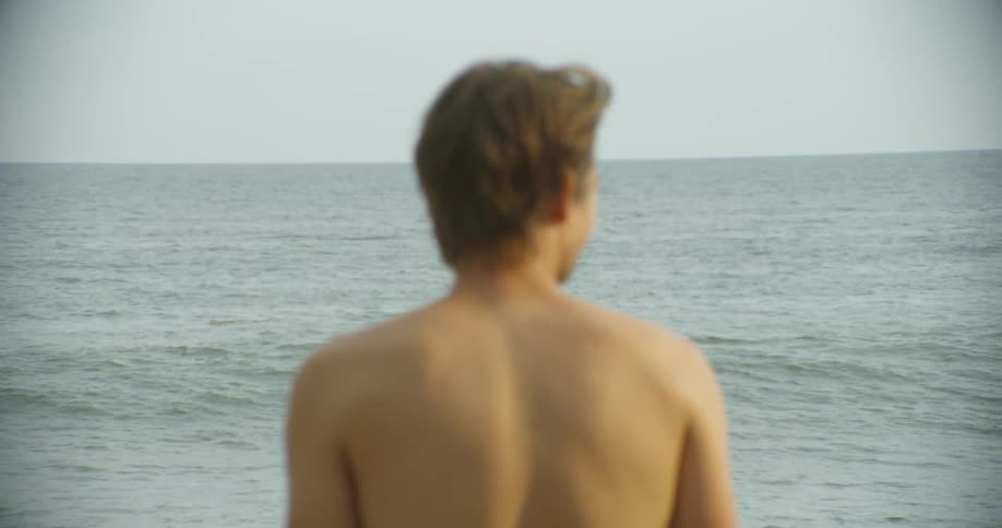 A man looks out towards the ocean