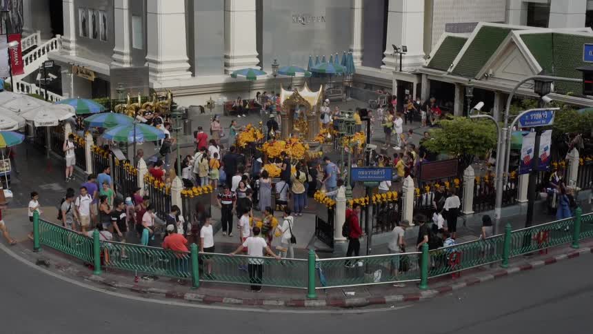 A crowd of people are walking into the attraction