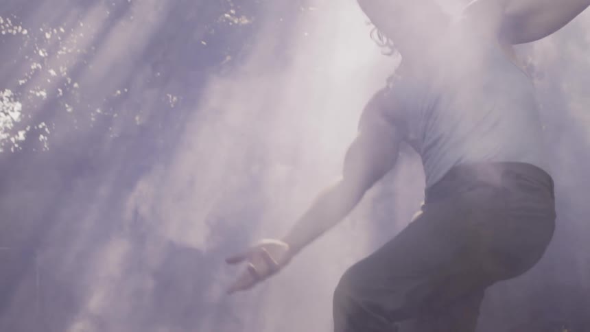 Man Dances Wildly in Smoke and Rays of Sunshine
