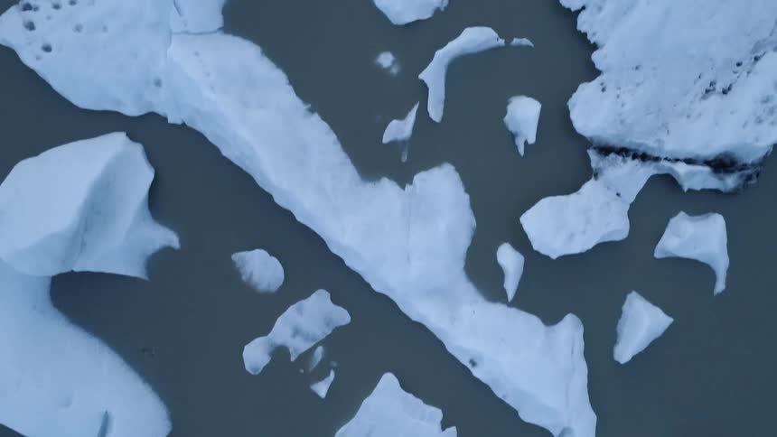 Snow and ice float on water in the wilderness
