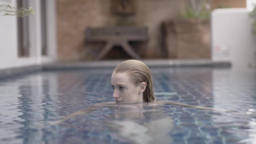 A woman soaks in the swimming pool