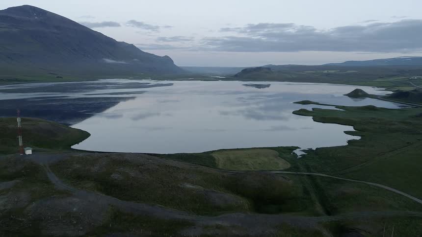 The lake ahead is calm near the mountain