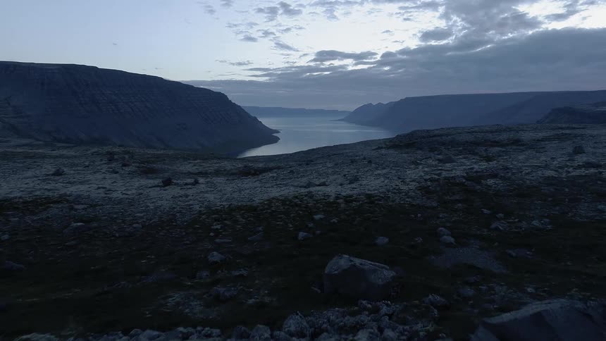 A rocky landscape overlooks the water