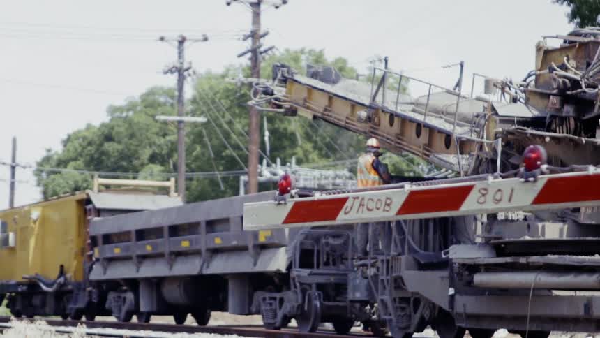 A man works on a stopped train