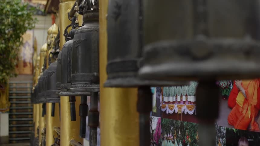 Prayer bells are swaying in the breeze outside a shrine in japan in daylight