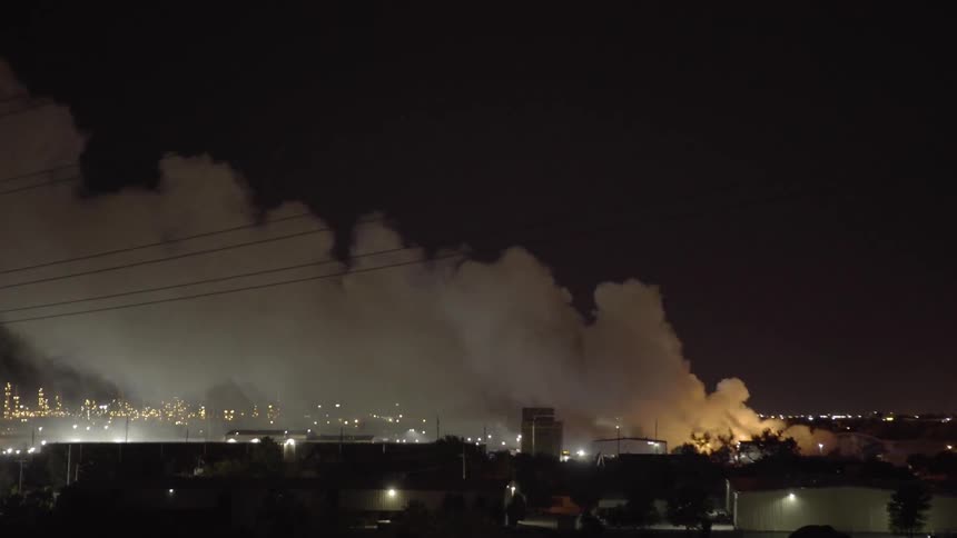 Smoke pours into the night sky