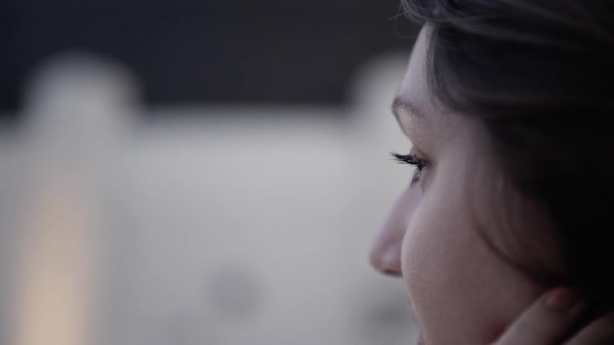Closeup of Woman Looking Out at City