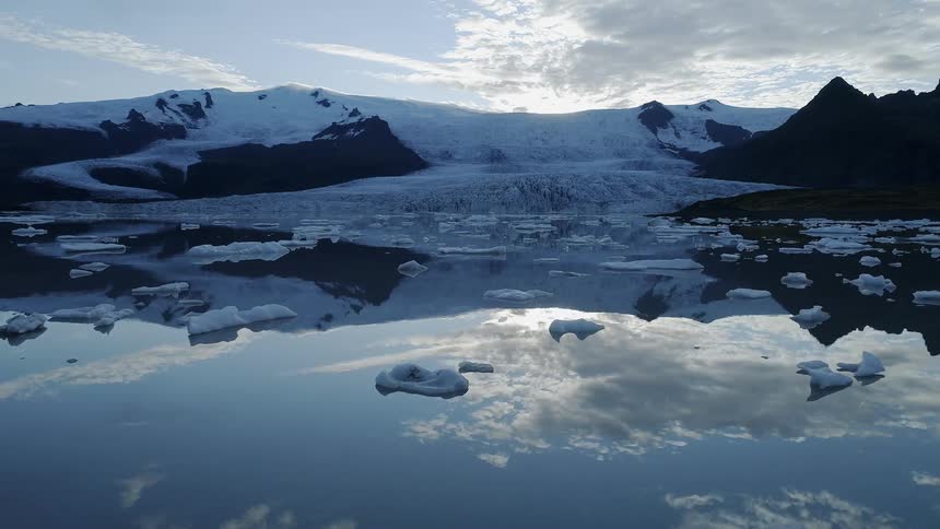 Ice and snow float on a lake in the wilderness