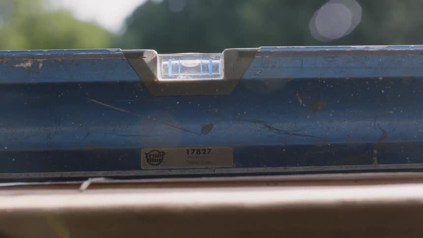 A leveling tool is used outside