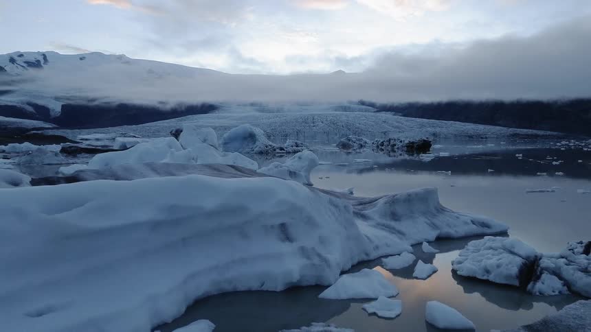 Ice and snow float on a lake in the wilderness