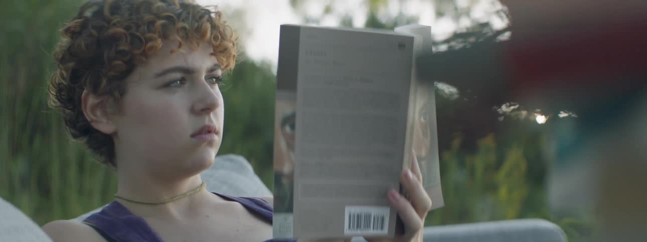 A woman puts down her book